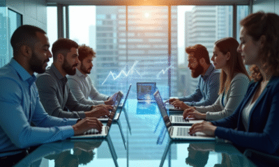 Groupe de professionnels autour d'une table avec graphiques holographiques