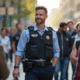 Policier en extérieur dans un environnement urbain avec des citoyens